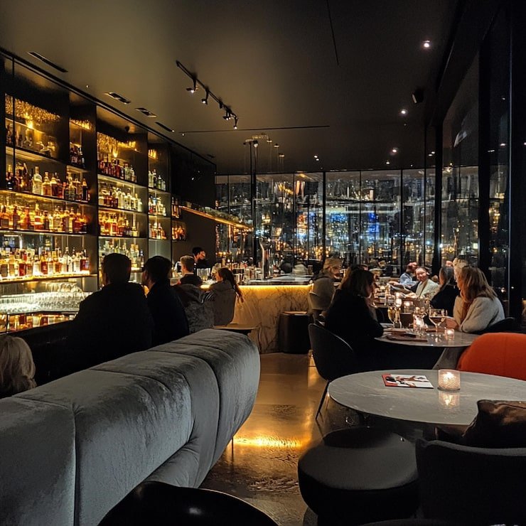 trendy-lounge-with-modern-decor-people-relaxing-with-cocktails_1327465-20139